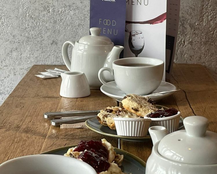 a cream tea for two of scones with clotted cream and jam and pots of tea at the wine cellar