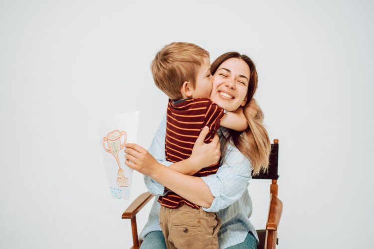 Young boy hugging his mother