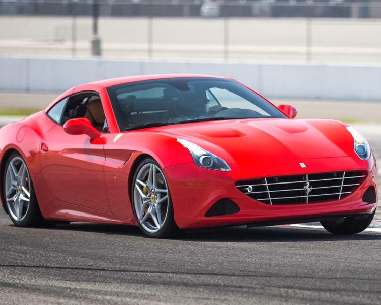 a red ferrari california driving around a race track as part of a ferrari driving experience day