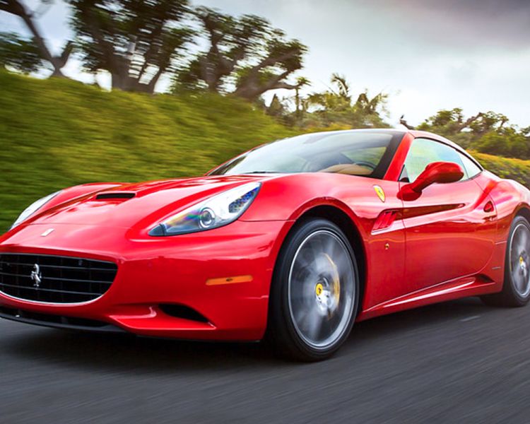 a red ferrari california on a race track as part of a ferrari driving experience day
