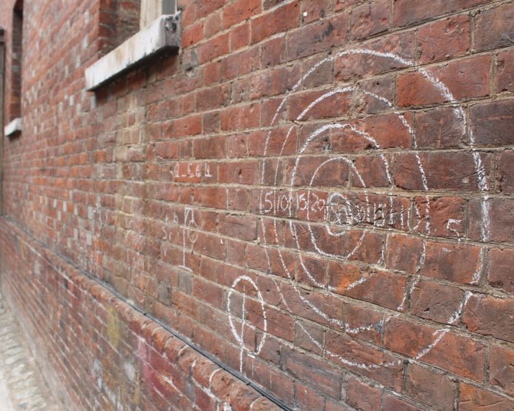 Childrens graffiti on a brick wall used on the show seen on a call the midwife locations tour
