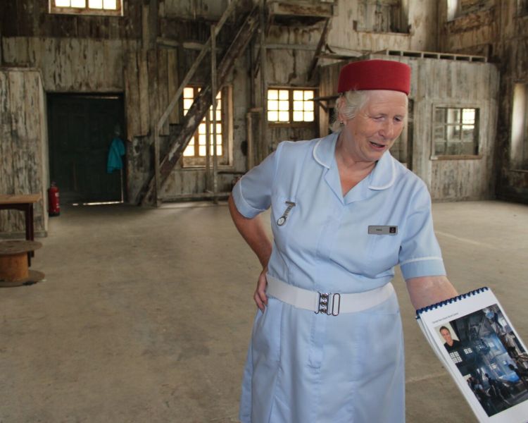 Midwife guide showing group photos from the show inside a film location on a call the midwife locations tour
