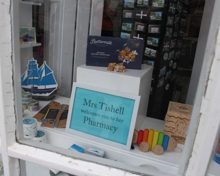 Shop window used for mrs tishells pharmacy seen on a doc martin locations tour in cornwal