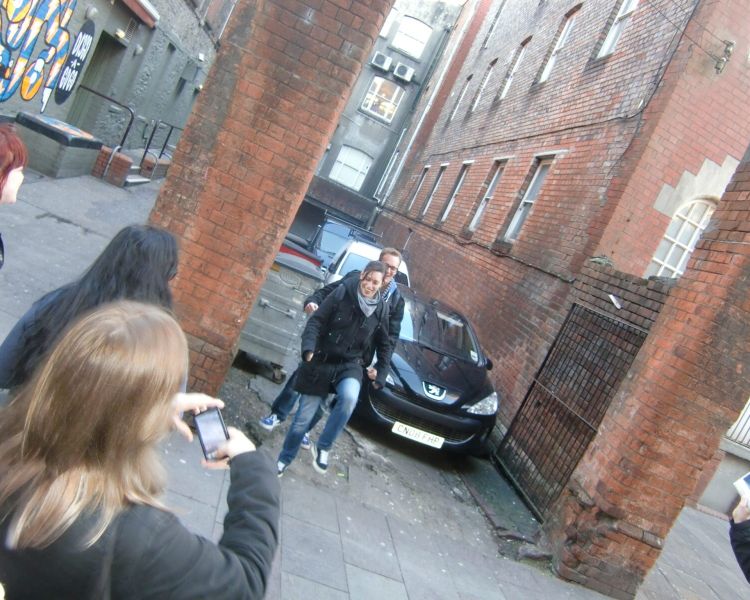 People posing for photo on street on a doctor who locations walking tour in cardiff