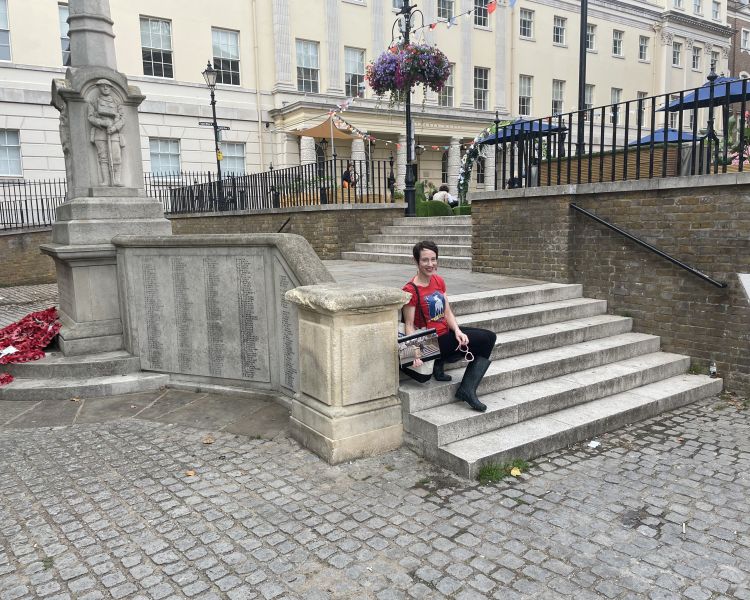 Woman sat on steps seen on a ted lasso walking tour in london