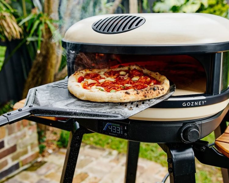 pizza making in an outdoor pizza oven at cookery class