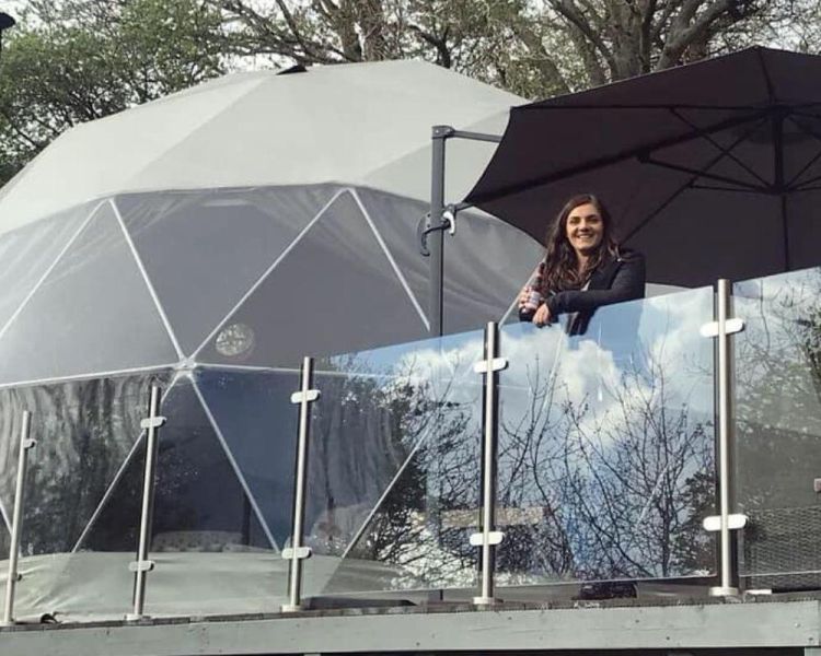 Lady on balcony outside star dome
