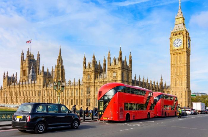 Houses of parliament and big ben with black cab and red buses in front