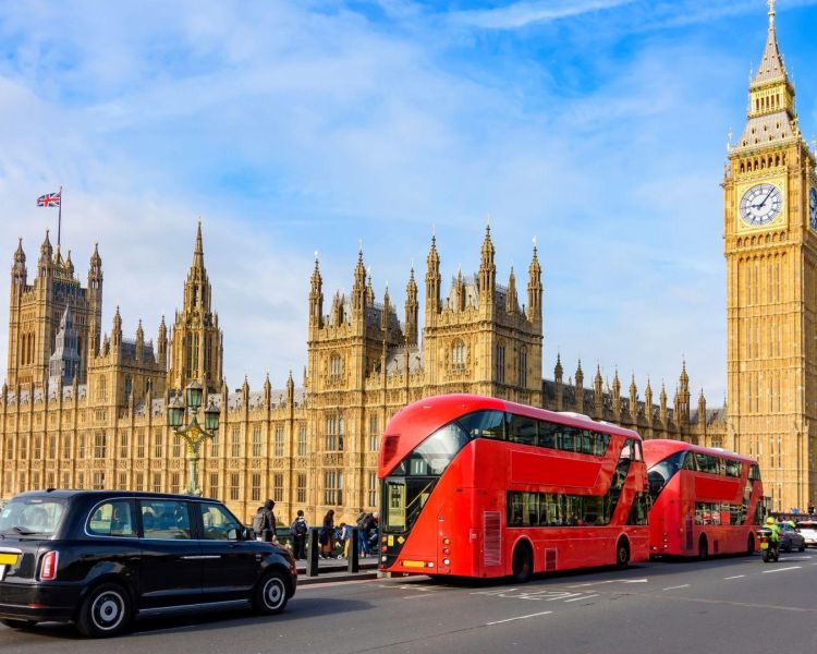 Houses of parliament and big ben with black cab and red buses in front