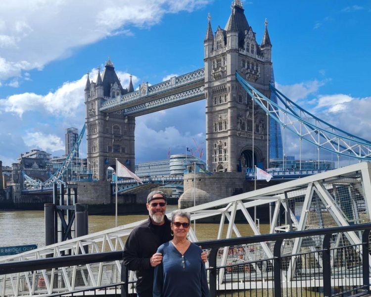 Couple posing for photo in front of tower bridge on a tour of london