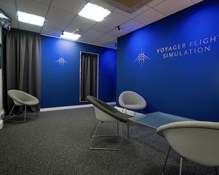 the waiting area with comfy chairs at a flight simulator experience at luton airport