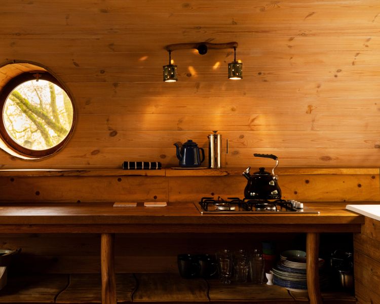 the kitchen area inside a treehouse in the woods in wales