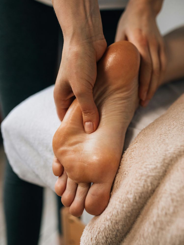 woman having a muscle recovery foot massage