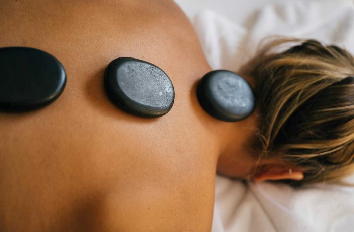 woman having a hot stone back massage treatment