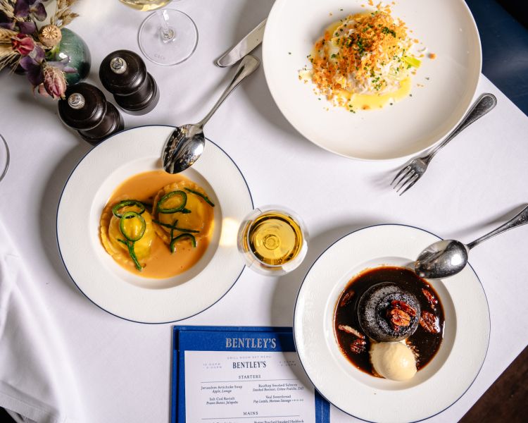 a table laid out for a seafood dining experience at bentley's mayfair