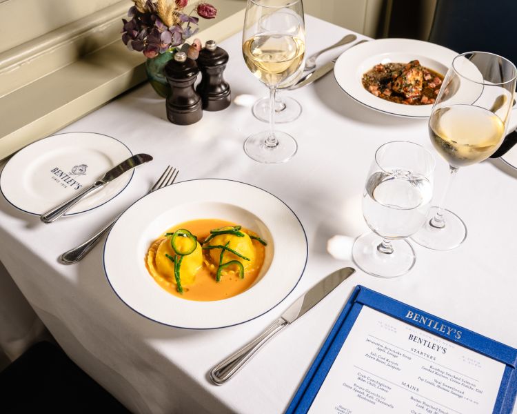 a table laid out for a seafood dining experience at bentley's mayfair