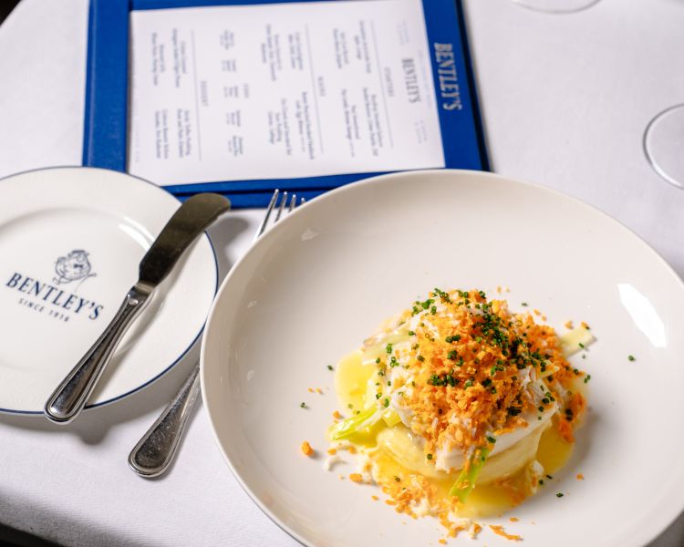 a table laid out for a seafood dining experience at bentley's mayfair