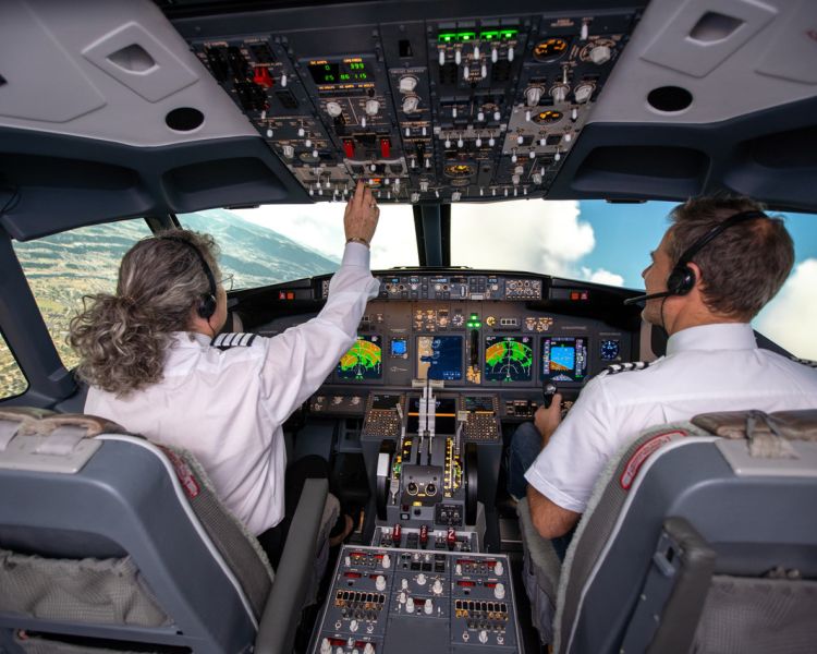 man and woman in the cockpit of a boeing 737 flight simulator at luton airport