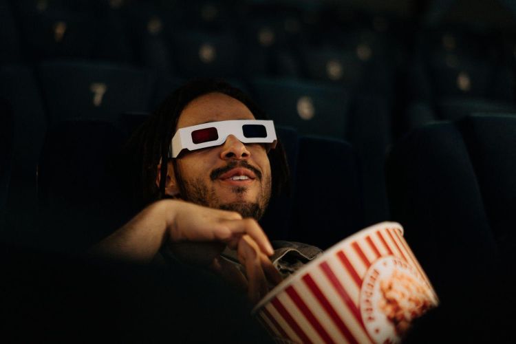 Man wearing 3d glasses watching film in cinema