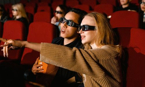Movie goers wearing 3d glasses in cinema