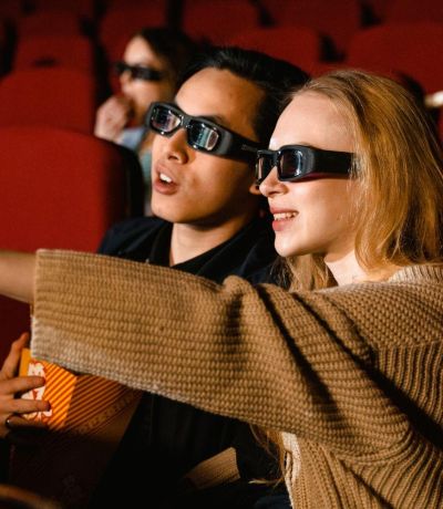 Movie goers wearing 3d glasses in cinema