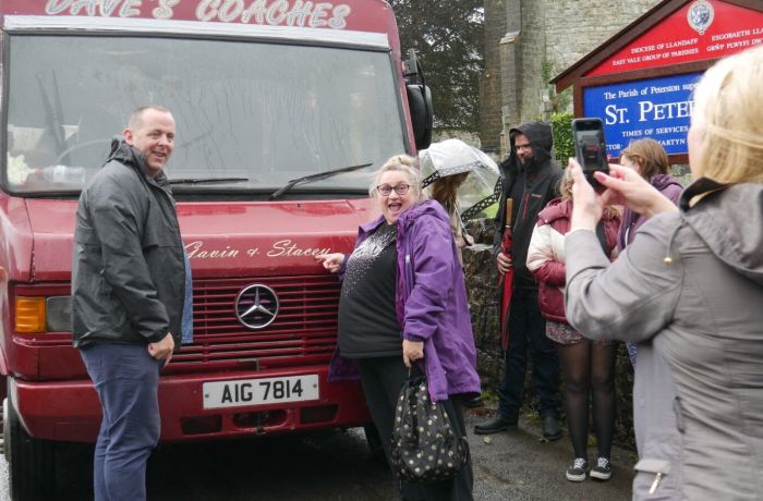 People having photo infront of daves coach on gavin and stacey tour