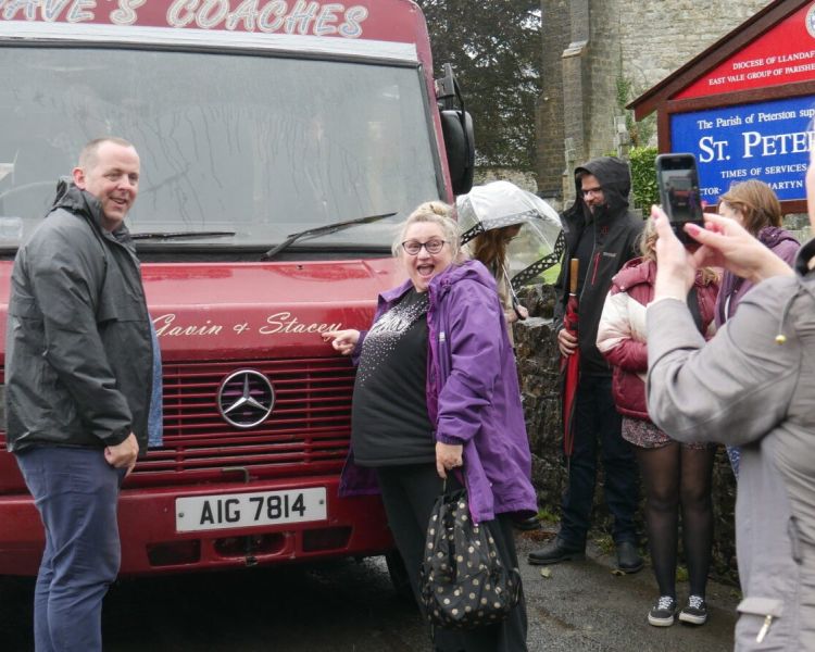 People having photo infront of daves coach on gavin and stacey tour