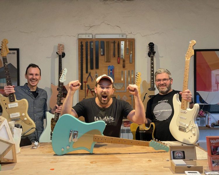 3 men holding guitars