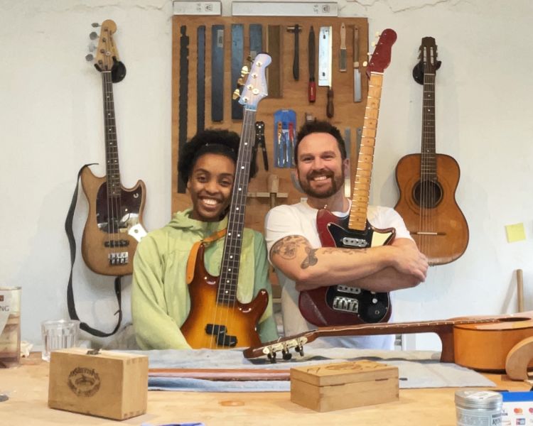 Man and woman holding electric guitars