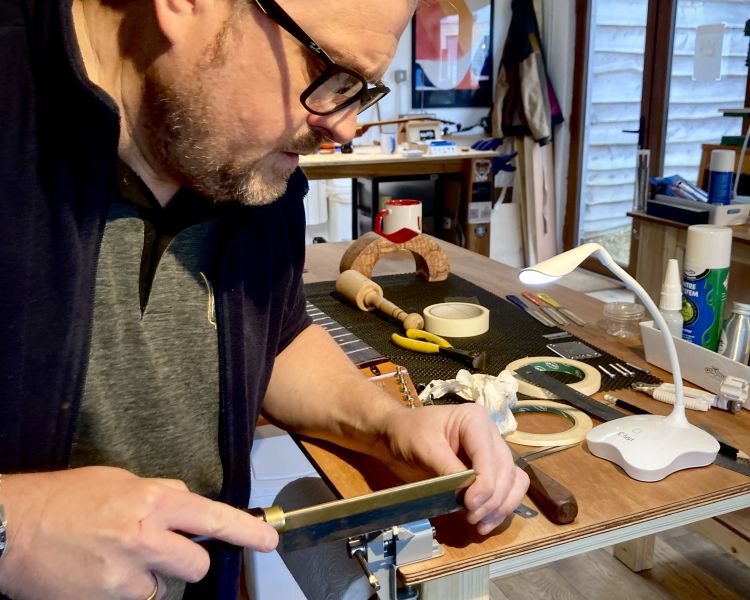 Man crafting a guitar