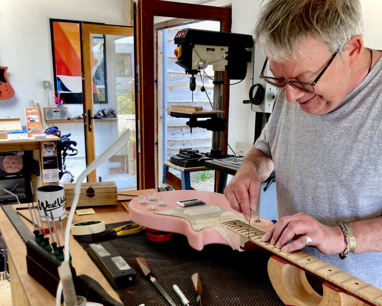Man working on a guitar