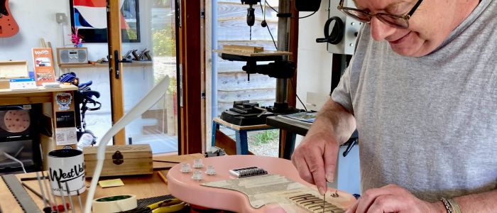 Man working on a guitar