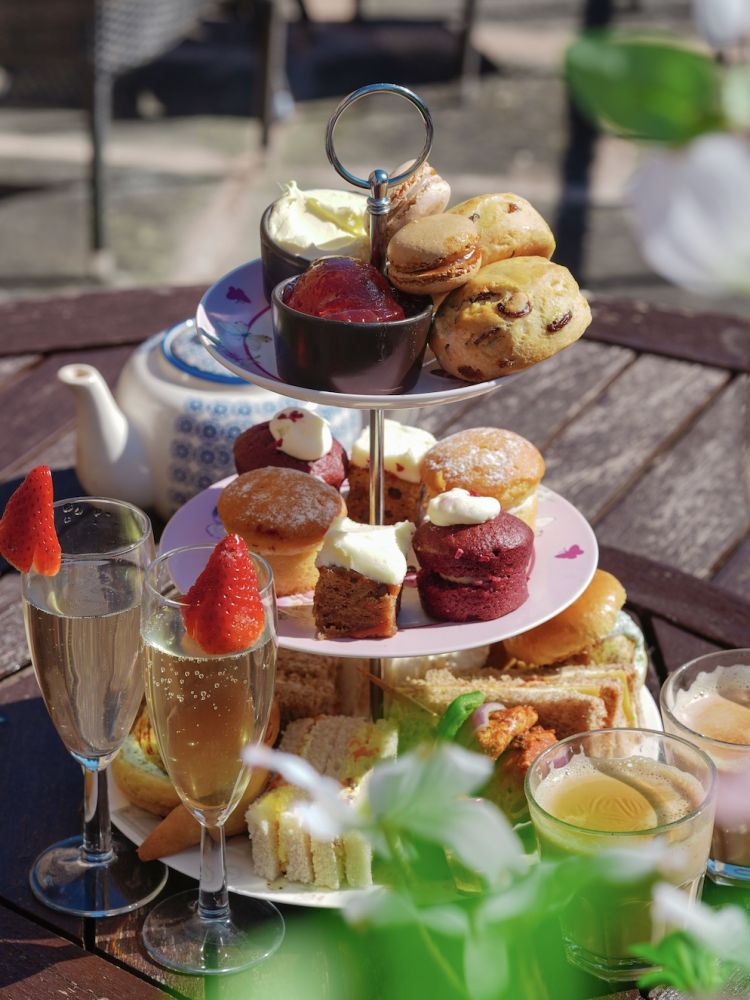 afternoon tea laid out on table outside on the terrace at hotel in lancashire