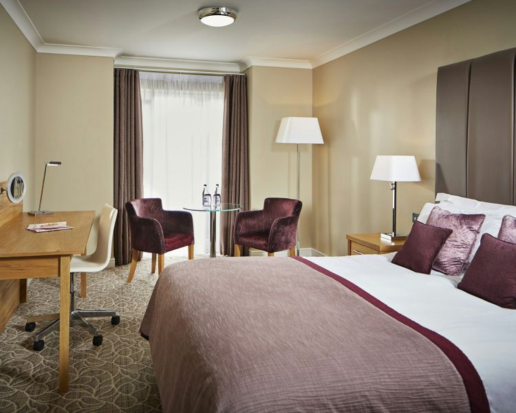 double room with armchairs and window on hotel in oswestry