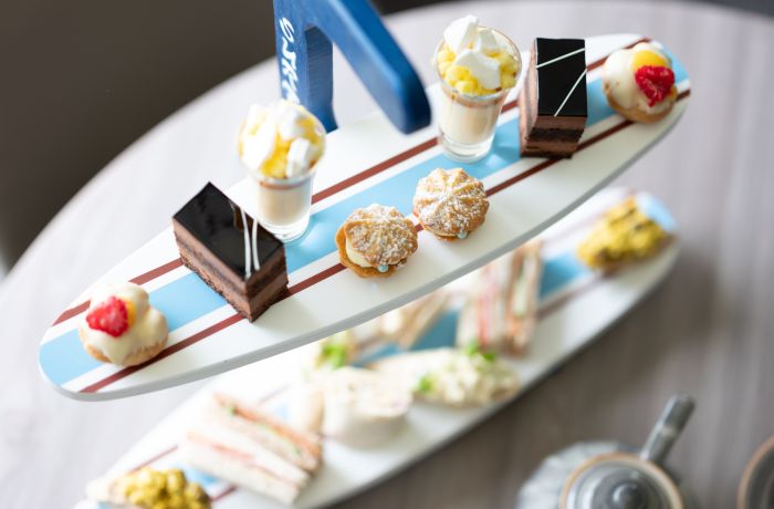 afternoon tea displayed on a surfboard display stand for an afternoon tea at a hotel and spa in hampshire