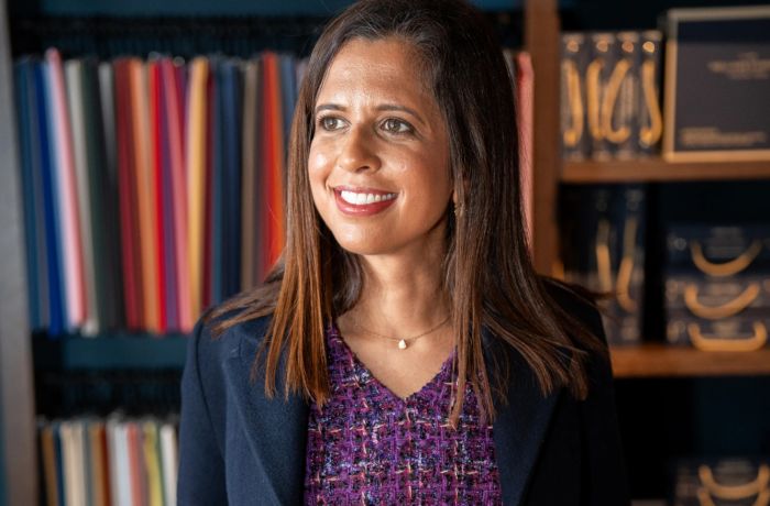 woman wearing a bespoke coat designed and made in savile row london