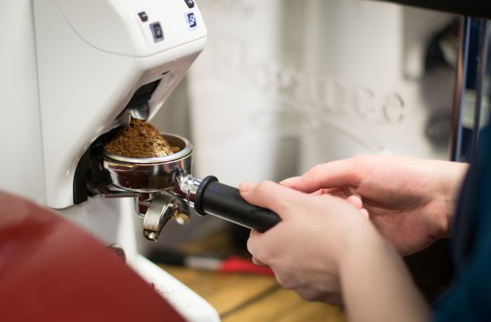 person on a barista coffee course working at coffee machine