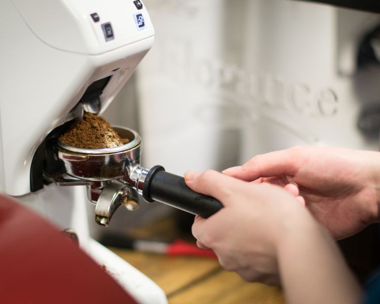 person on a barista coffee course working at coffee machine