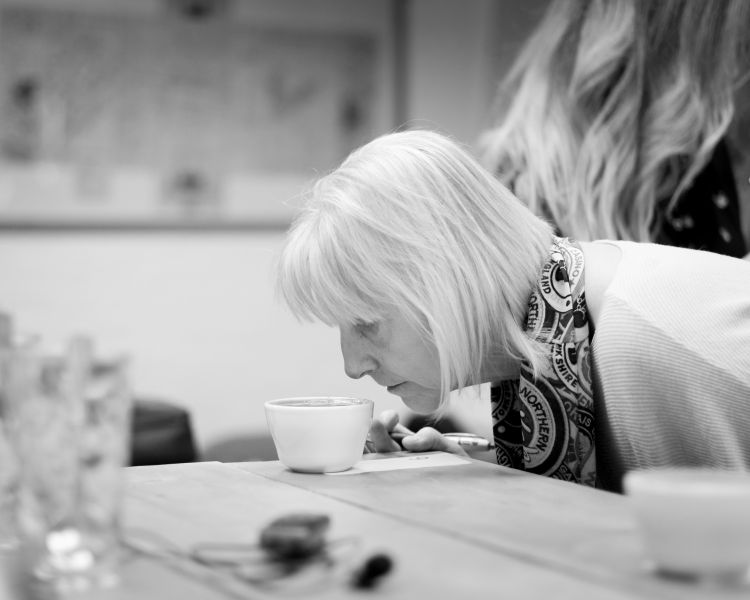 woman smelling coffee on a create your own coffee blend experience