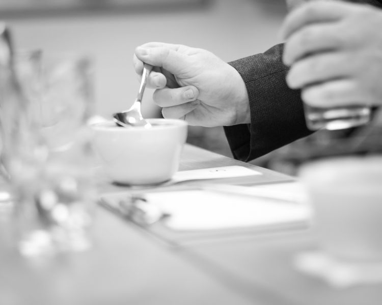 stirring coffee in a cup on a create your own coffee blend experience