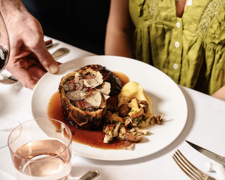 A beef wellington meal being served at corrigans mayfair