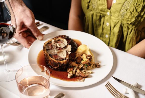 A beef wellington meal being served at corrigans mayfair