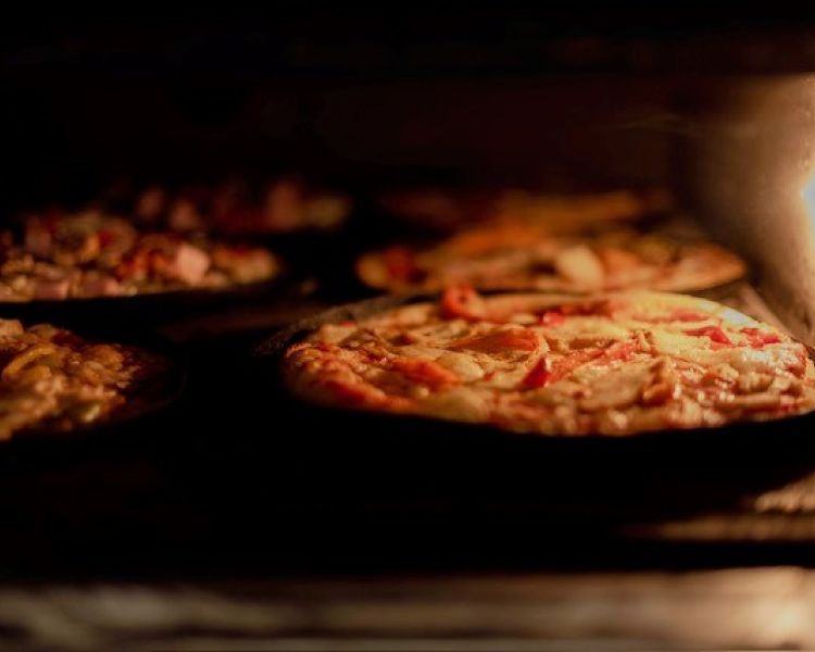 Pizzas in the oven at azzurro restaurant