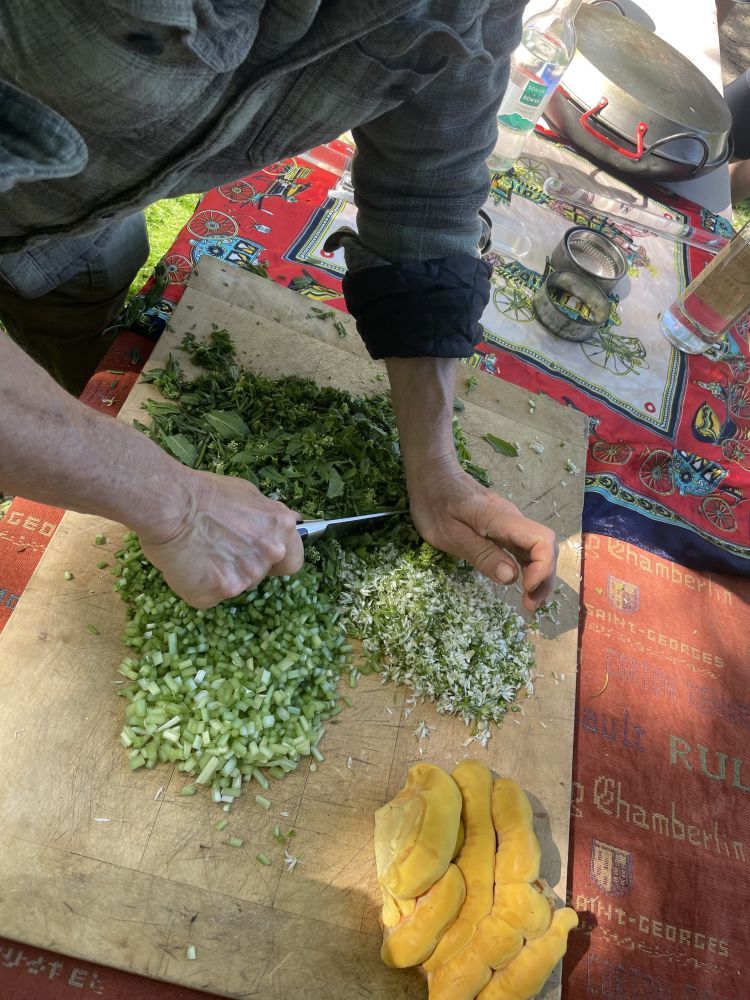 Man chopping up foraged herbs on a foraging experience