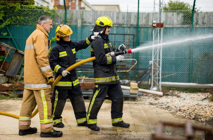 Holding a water hose firefighter experience min