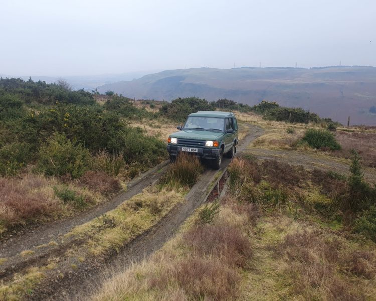 Green 4x4 on an off road course