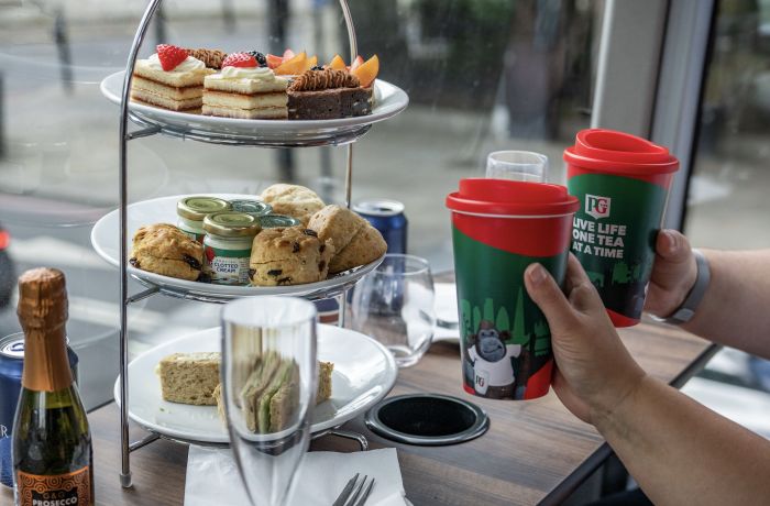 Couple drinking tea on a pg tips afternoon tea london tour bus