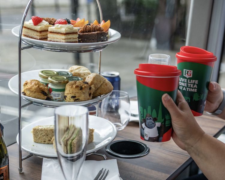 Couple drinking tea on a pg tips afternoon tea london tour bus