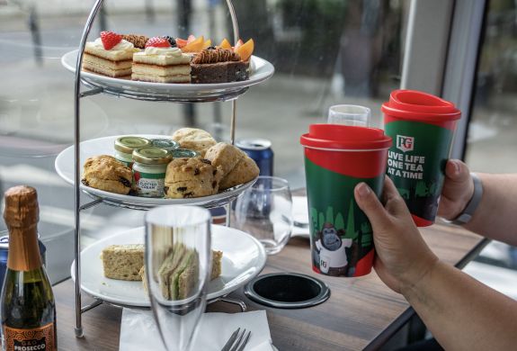 Couple drinking tea on a pg tips afternoon tea london tour bus