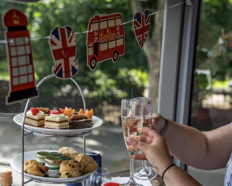 Couple drinking prosecco at an afternoon tea on a pg tips london bus tour